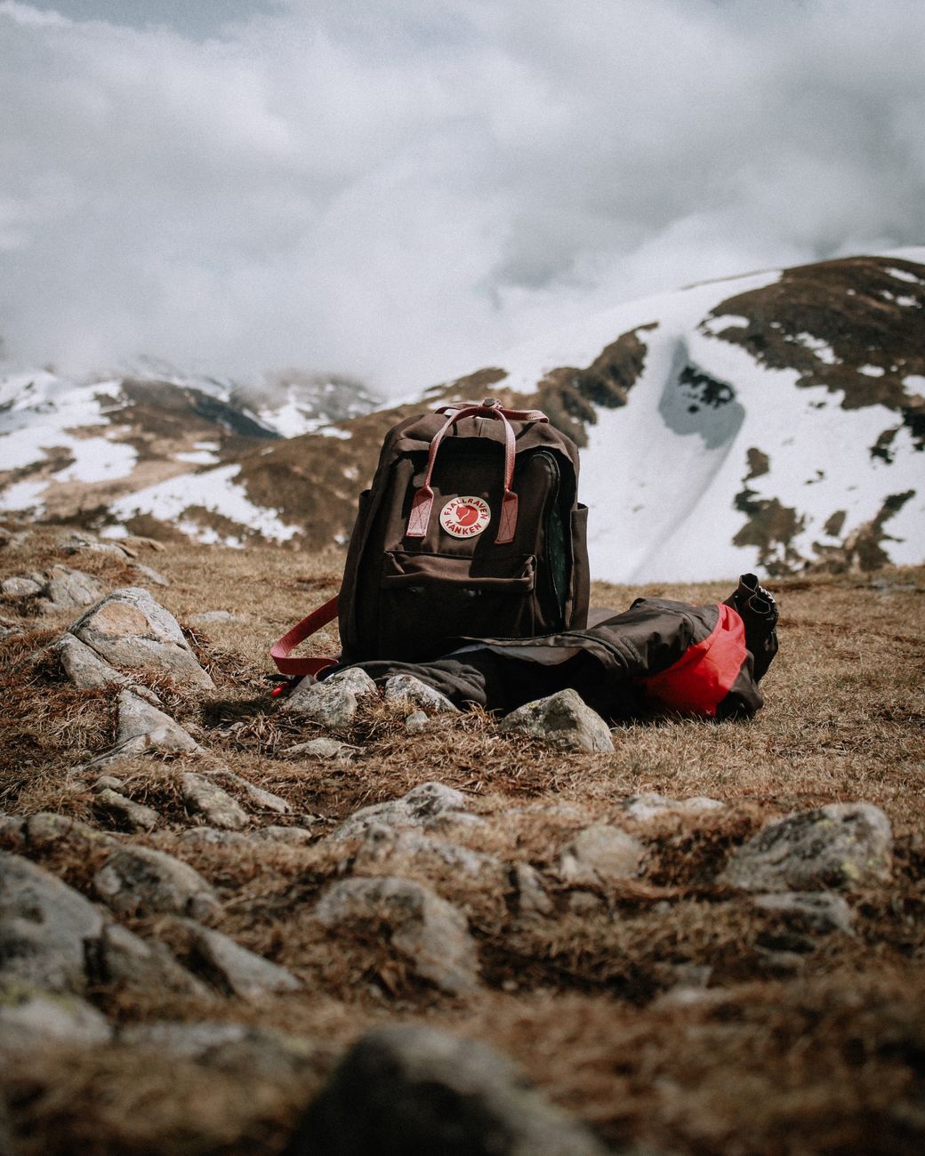 Backcountry hiking boots and backpack in New Zealand alpine meadow
